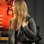 Penny’s grey blazer and black handbag on The Big Bang Theory