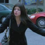 Penny’s black coat and blue bag on Happy Endings