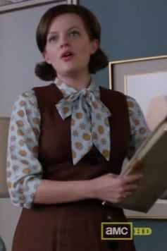 Peggy’s printed blouse under a brown dress on Mad Men