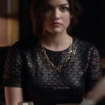 Aria’s black textured short sleeve dress and green square necklace on Pretty Little Liars