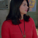 Penny’s red knit sweater and long leather/gold necklace on Happy Endings