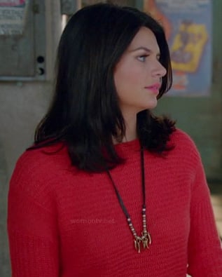 Penny’s red knit sweater and long leather/gold necklace on Happy Endings