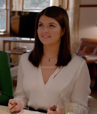 Penny's white v-neck split blouse on Happy Endings