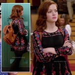 Tessa’s black long sleeved floral dress and tan backpack on Suburgatory