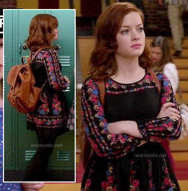 Tessa's black long sleeved floral dress and tan backpack on Suburgatory