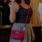 Penny’s grey dipped hem skirt and red crossbody bag on Happy Endings