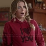 Polly’s red “I Love You” hoodie on How To Live With Your Parents