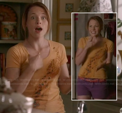 Daphne’s orange peacock tee and purple shorts on Switched at Birth