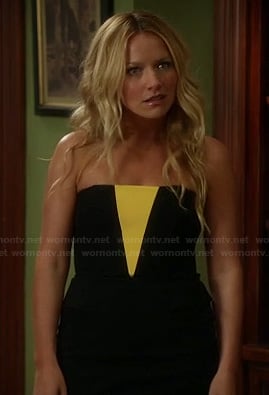 Chloe’s black strapless dress with neon yellow “V” on The Goodwin Games