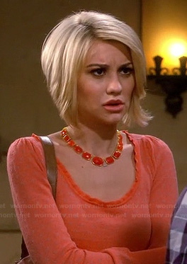 Riley's orange top with fitted waist and orange necklace on Baby Daddy