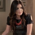 Aria’s black leather-look split sleeve dress and coral spiked necklace on Pretty Little Liars