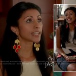 Divya’s white, black and orange colorblock peplum top on Royal Pains