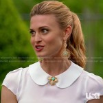 Paige’s white peter pan collar top and bug brooch on Royal Pains