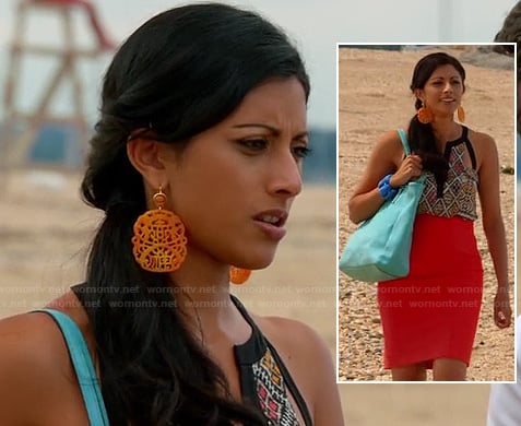 Divya's orange statement earrings, tribal print cutout top and red high waisted skirt on Royal Pains