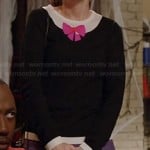 Jess’s black sweater with pink bow and purple skirt on New Girl