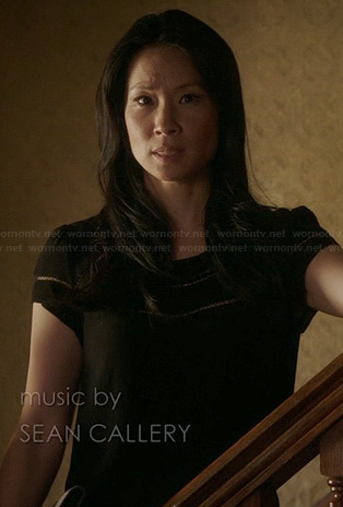 Joan’s black dress with inset stripes on Elementary