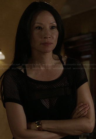 Joan's black perforated dress on Elementary