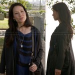 Joan’s blue and black stripe t-shirt dress and black purse on Elementary