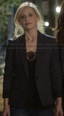 Sydney's black lace cami and dark pinstripe blazer on The Crazy Ones