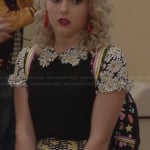 Carrie’s black top with daisy applique and yellow print skirt on The Carrie Diaries