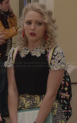 Carrie's black top with daisy applique and yellow print skirt on The Carrie Diaries