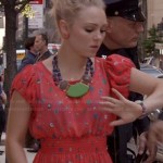 Carrie’s red printed dress and green statement necklace on The Carrie Diaries