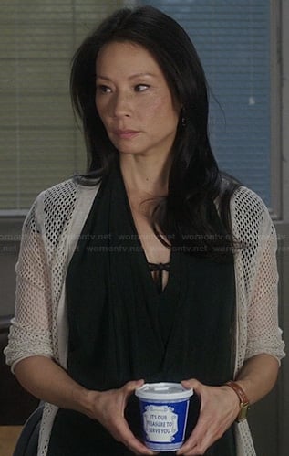 Joan's black draped wrap dress and perforated cardigan on Elementary