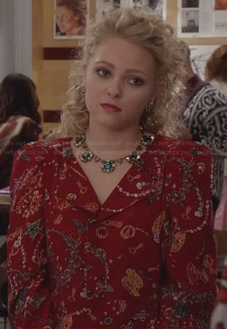 Carrie's red printed jacket and green flower necklace on The Carrie Diaries