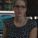 Felicity’s printed peplum dress and peacock feather earrings on Arrow