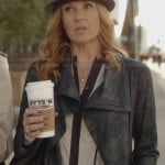 Rayna’s white contrast trimmed blouse, leather jacket and leather fedora on Nashville