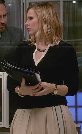 Jeannie’s cream pleated skirt and black split-neck sweater on House of Lies