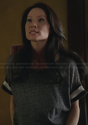 Joan’s grey tee with black and white striped sleeves on Elementary