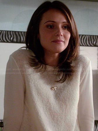 April's white sweater with sheer sleeves and gold elephant necklace on Chasing Life