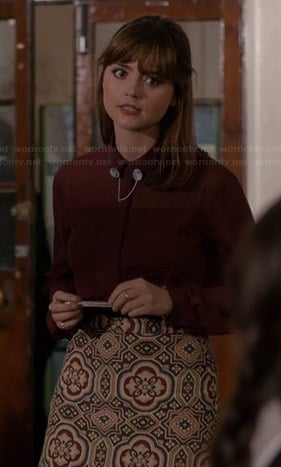 Clara’s sheer burgundy blouse and printed skirt on Doctor Who