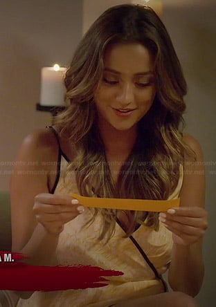 Shay Mitchell's orange wrap dress with black trim on Pretty Little Liars