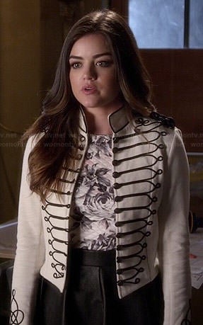 Aria’s white military style jacket, rose print top and pleated leather skirt on Pretty Little Liars