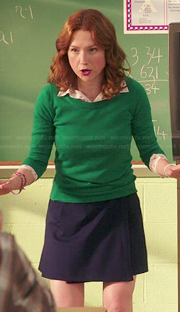 Kimmy’s green sweater, flamingo print shirt and navy wrap skirt on Unbreakable Kimmy Schmidt