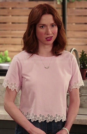 Kimmy's pink top with flower trim on Unbreakable Kimmy Schmidt