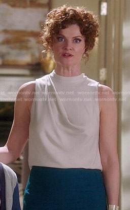 Evelyn's white high-neck draped top on Devious Maids