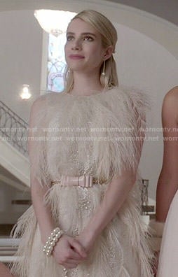 Chanel’s cream feather dress and pink bow belt on Scream Queens