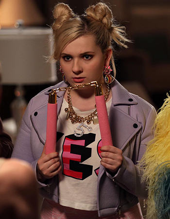 Chanel 5's 'YES' top and purple moto jacket on Scream Queens