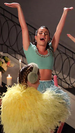 Hester’s green embellished crop top and feather peplum skirt on Scream Queens