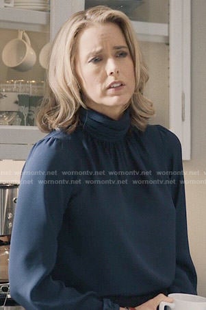 Elizabeth’s navy blue turtleneck blouse on Madam Secretary