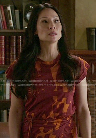 Joan's orange and red printed dress on Elementary