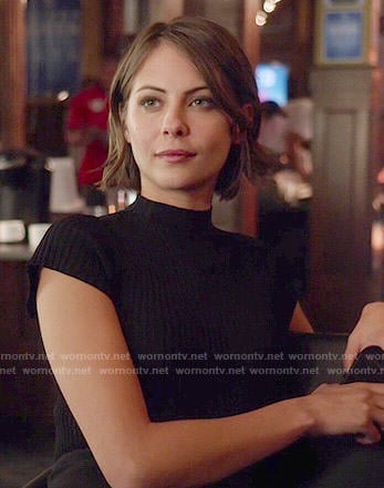 Thea’s black mock-neck top on Arrow