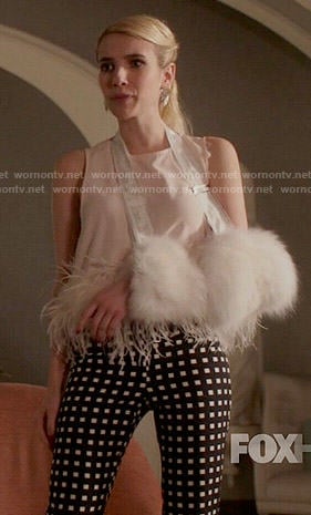 Chanel's checked trousers and feather trim top on Scream Queens