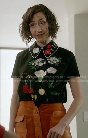 Carol’s flower embroidered top and suede button-front skirt on Last Man on Earth