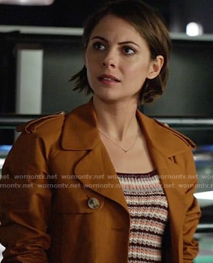 Thea's striped knit top and mustard trench coat on Arrow