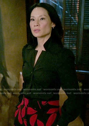 Joan's black and red leaf print trousers on Elementary