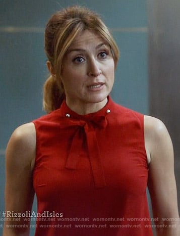 Maura's red tie neck top with pearls on Rizzoli and Isles